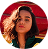 A contemplative woman with vibrant hair gazes thoughtfully.