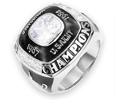 A silver championship ring with a large central gem and engraved details.