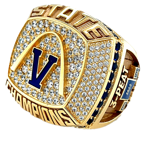 A detailed championship ring with a large blue 'V' and numerous diamonds.