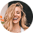 Smiling woman with wavy blonde hair and a bright expression.