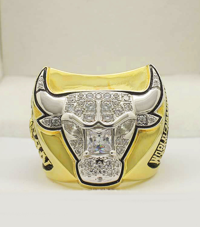 A yellow championship ring featuring a detailed bull's head design.