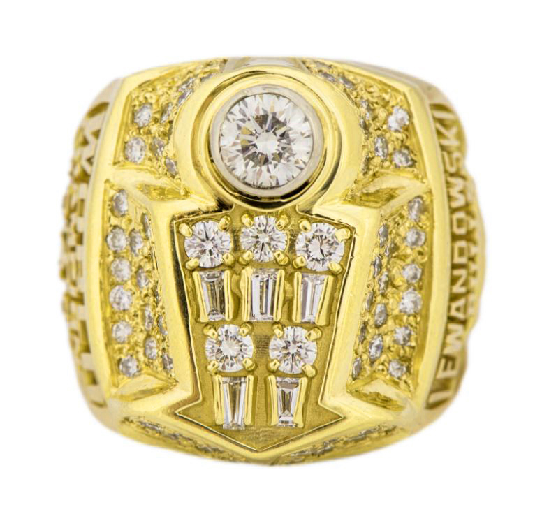 Gold ring with diamond and intricate design.