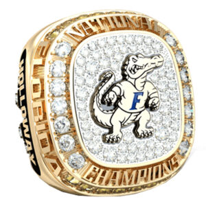 A detailed gold championship ring with a mascot and diamonds.