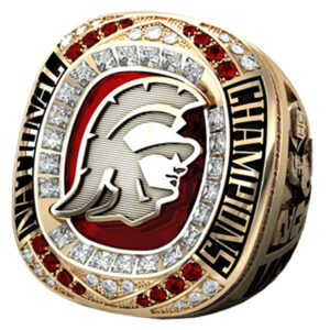 A detailed championship ring featuring a Trojan helmet and sparkling stones.
