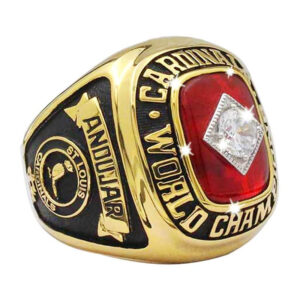 Close-up of a red and gold Cardinal World Champions ring with a diamond.