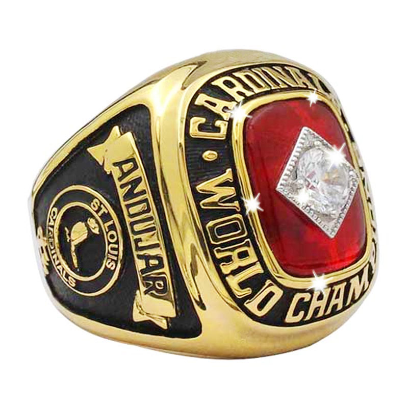 Close-up of a red and gold Cardinal World Champions ring with a diamond.