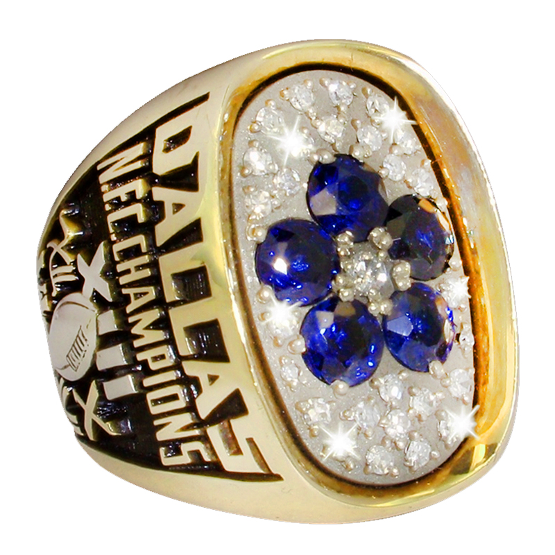 A Dallas Mavericks NBA championship ring with blue and white stones.