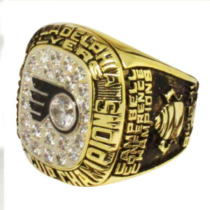 Close-up of a gold Philadelphia Flyers championship ring with diamonds.