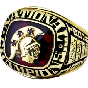 Gold championship ring with a Spartan helmet design and purple stars.