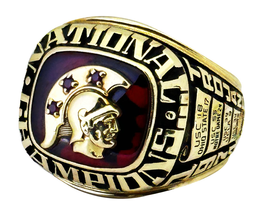 Gold championship ring with a Spartan helmet design and purple stars.
